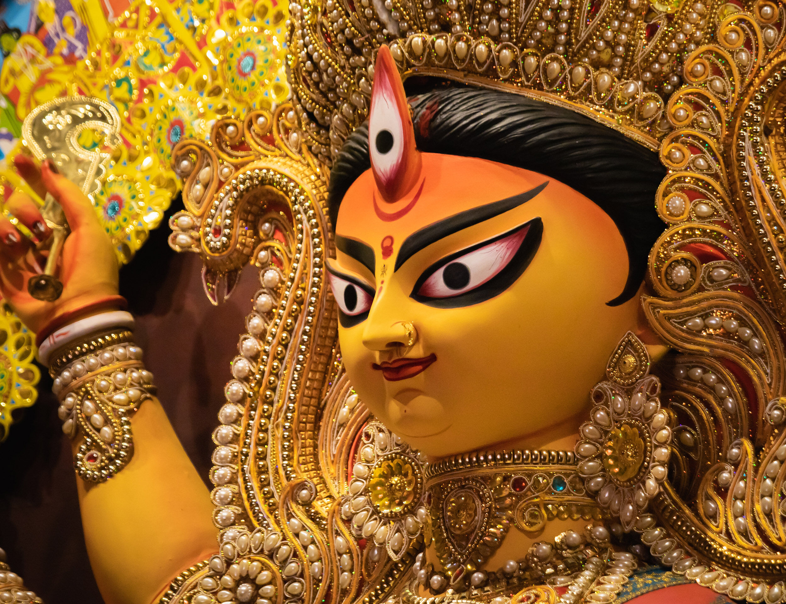 Close-up of Goddess Durga idol with traditional jewelry and crown during Navratri festival